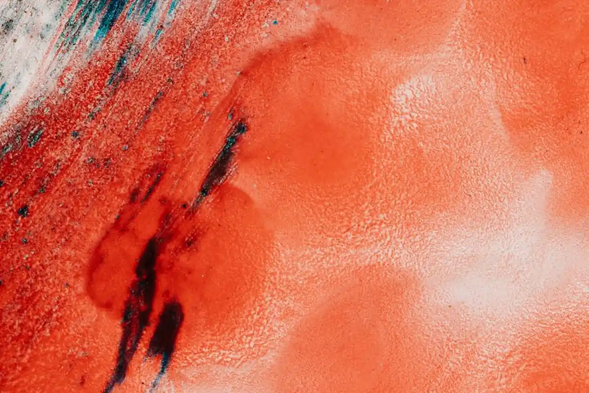 Close-up of a vivid red stain on fabric, illustrating a challenging stain on non-standard textiles