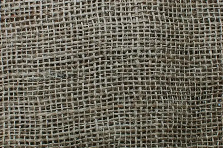Close-up of a coarse burlap weave showing an open, breathable lattice.