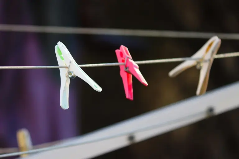 Clothesline with colorful clothespins drying clothes outdoors
