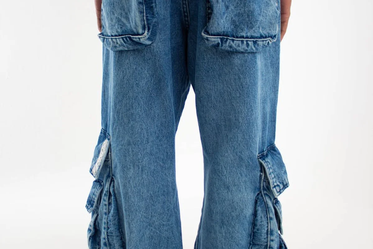 Close-up of blue denim jeans showing cotton fabric texture and cargo pockets