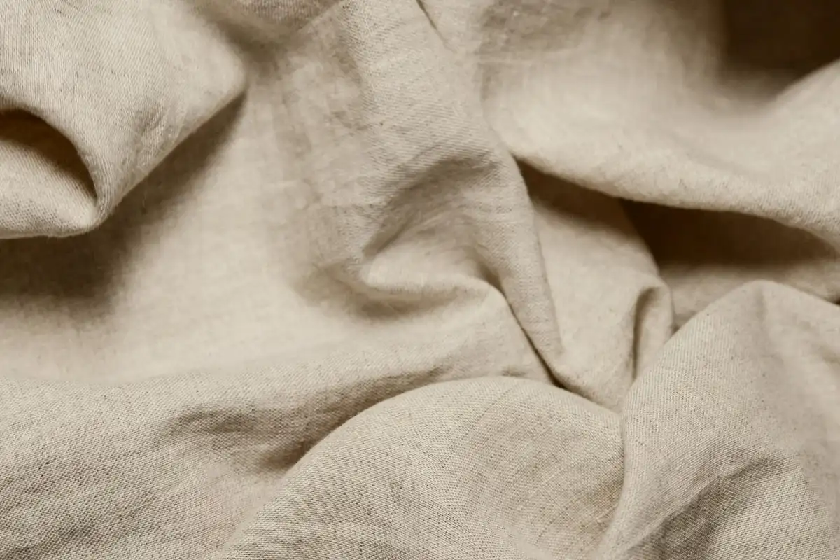 Close-up of beige cotton fabric with soft folds