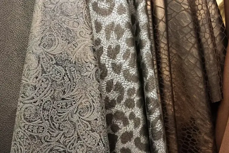 Rows of textured fabric swatches in metallic silver with a paisley design, a gray leopard-like pattern, and a brown snakeskin-like texture.