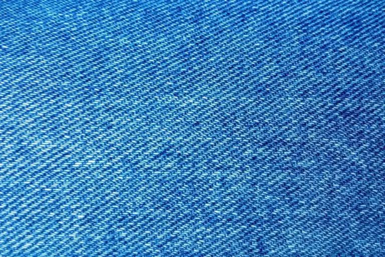 Close-up of blue denim fabric showing diagonal weave texture