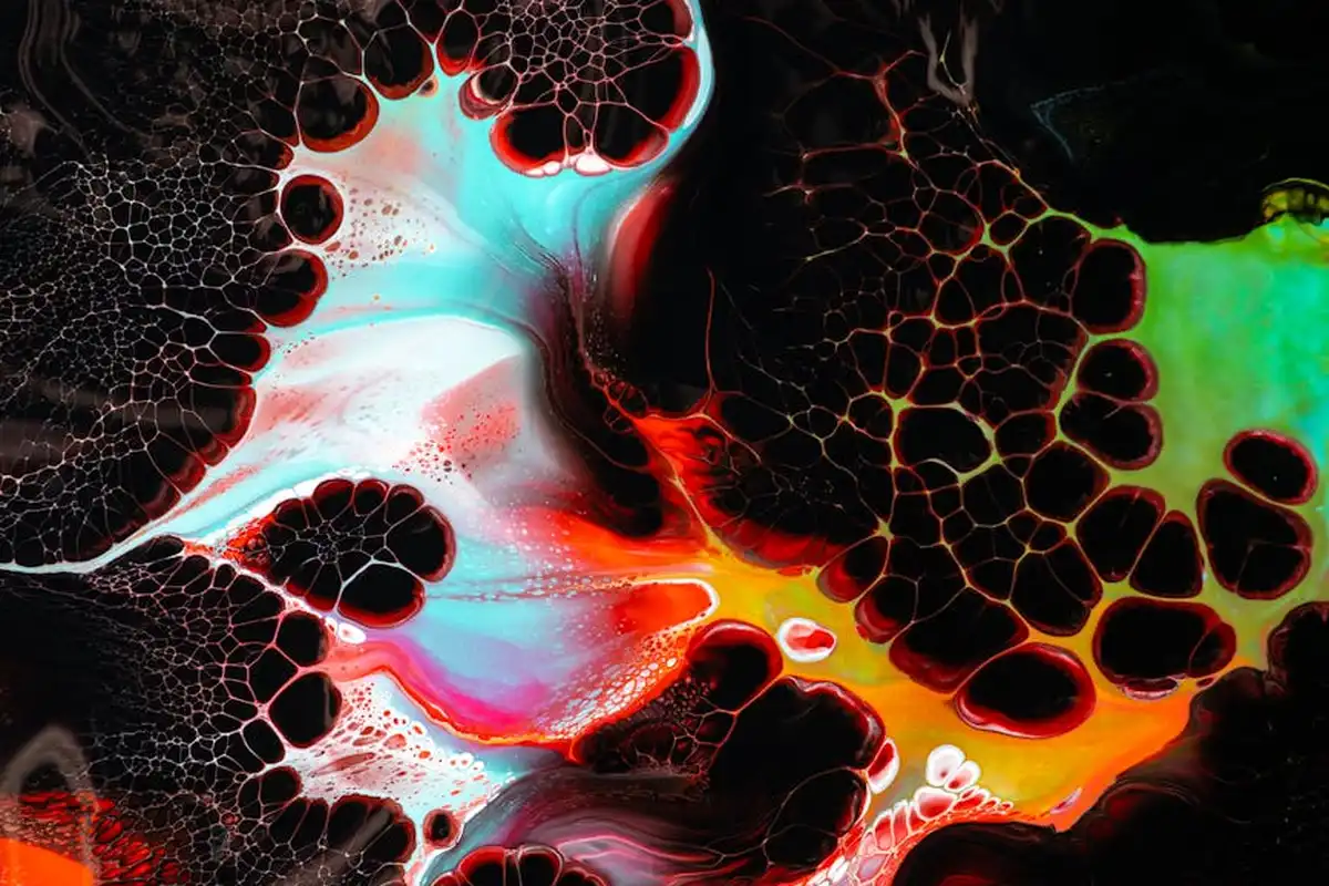 Abstract, colorful dye diffusion on a dark background representing dyeing of cotton and linen fabrics.