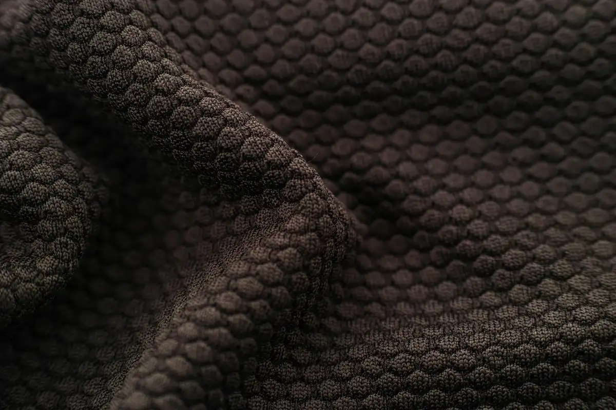 Close-up of dark brown textured fabric with a honeycomb-like pattern