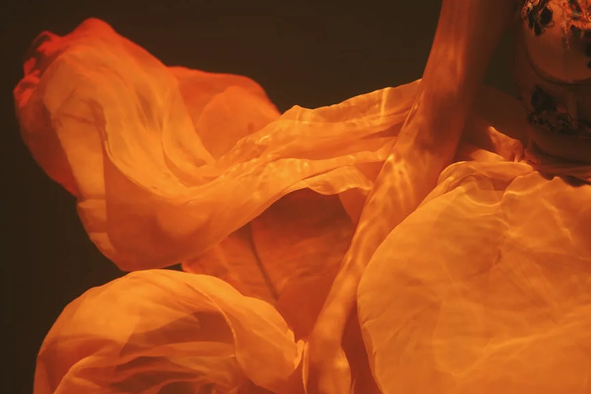 Close-up of flowing orange fabric with soft folds