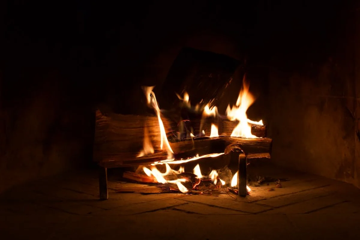 A warm lit fireplace with burning logs.