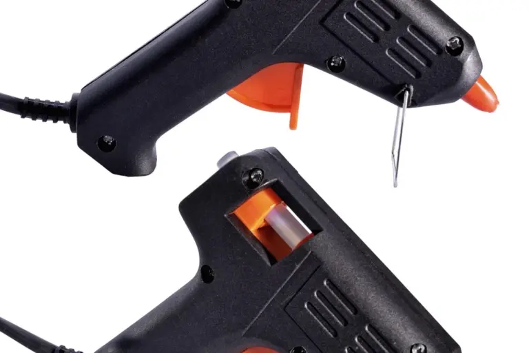 Two black hot glue guns with orange nozzles, ready for fabric and plastic bonding.
