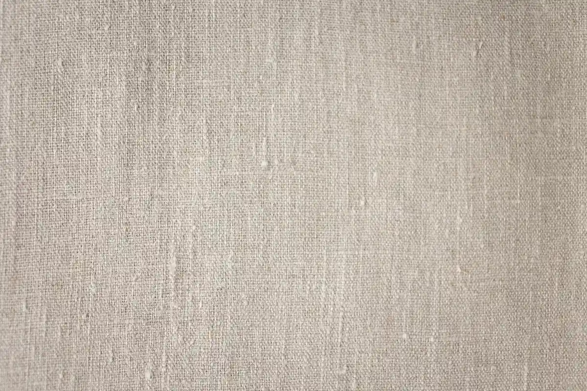 Close-up of beige linen fabric texture suitable for sewing prep