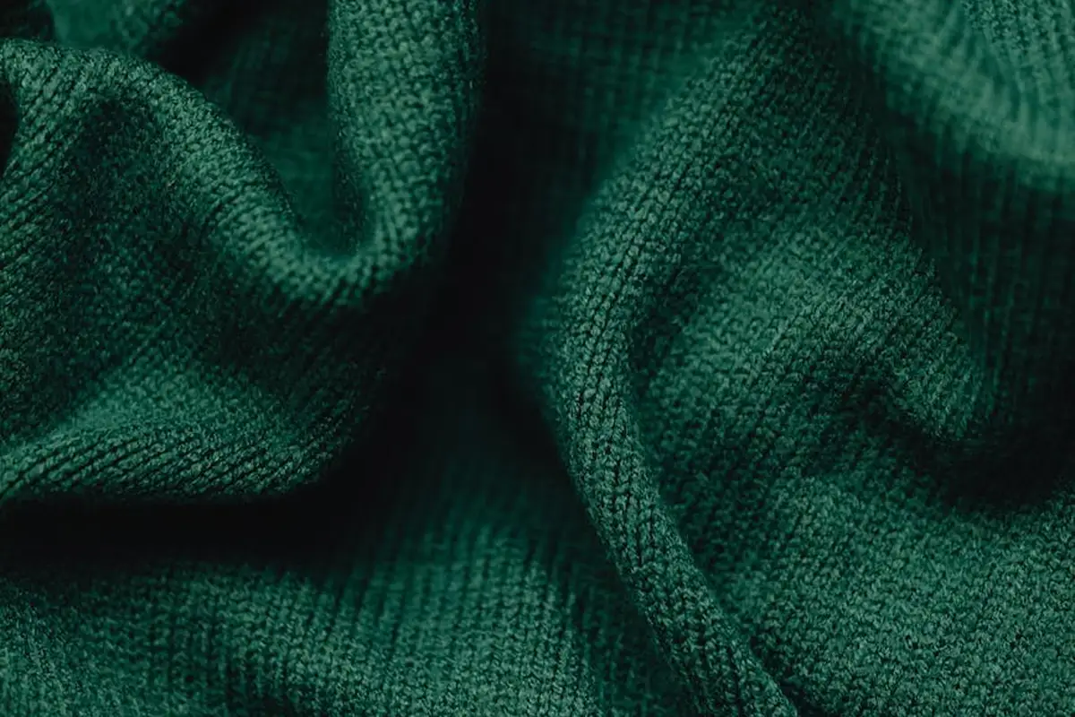 Close-up of rich green lyocell fabric showing soft texture and folds.