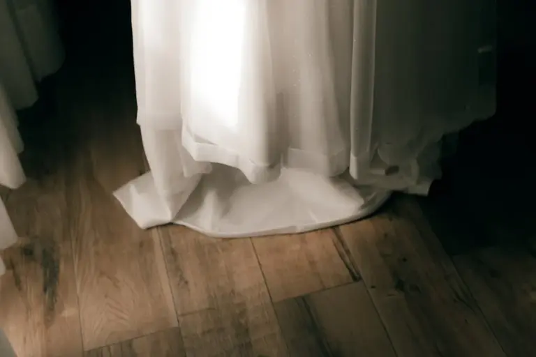 White modal fabric draped over a wooden floor