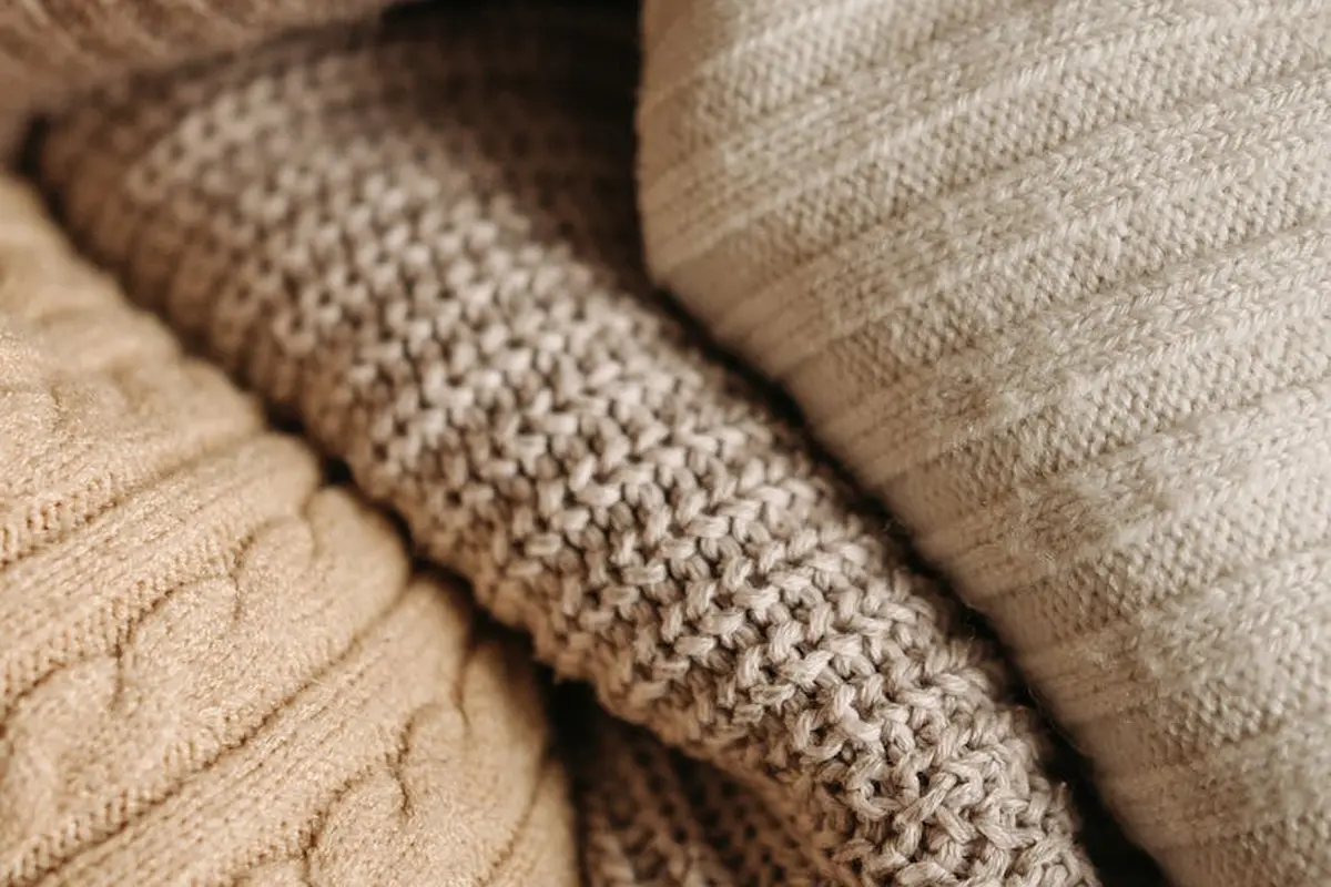 Close-up of soft beige knitted fabrics illustrating the plush texture and comfort associated with modal fibers