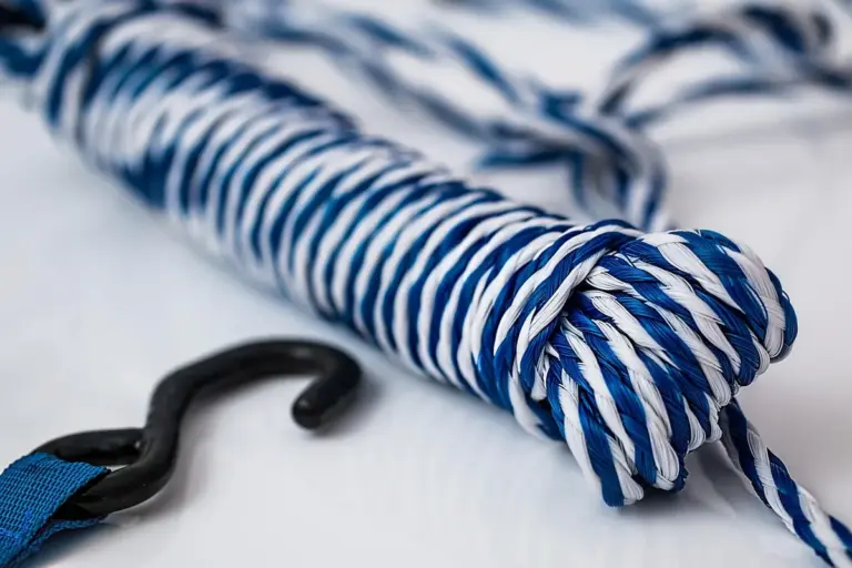Close-up of blue and white nylon rope with a black carabiner hook, illustrating nylon material used in printing and heat-pressing projects.