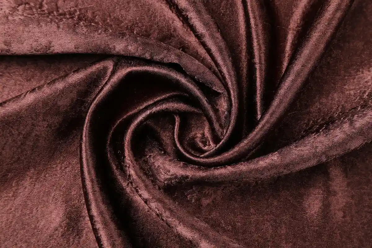 Close-up of brown nylon fabric with a soft, velvety texture and folds.
