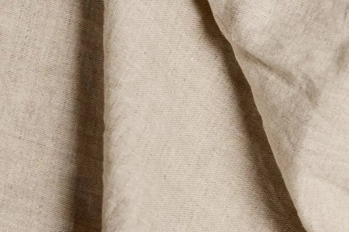 Close-up of light beige fabric texture, used to illustrate nylon material in heat pressing
