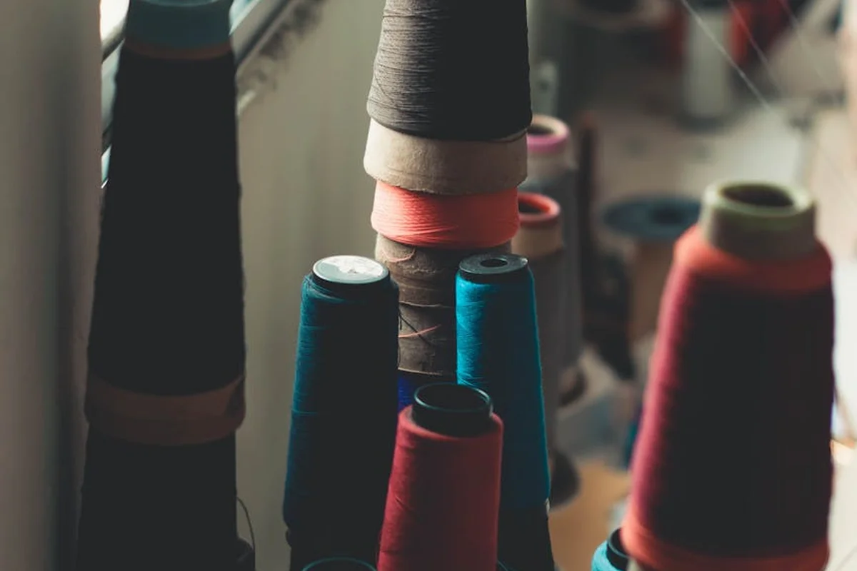 Close-up of colorful nylon thread spools in a textile workshop, illustrating texture and production context behind nylon fabric.