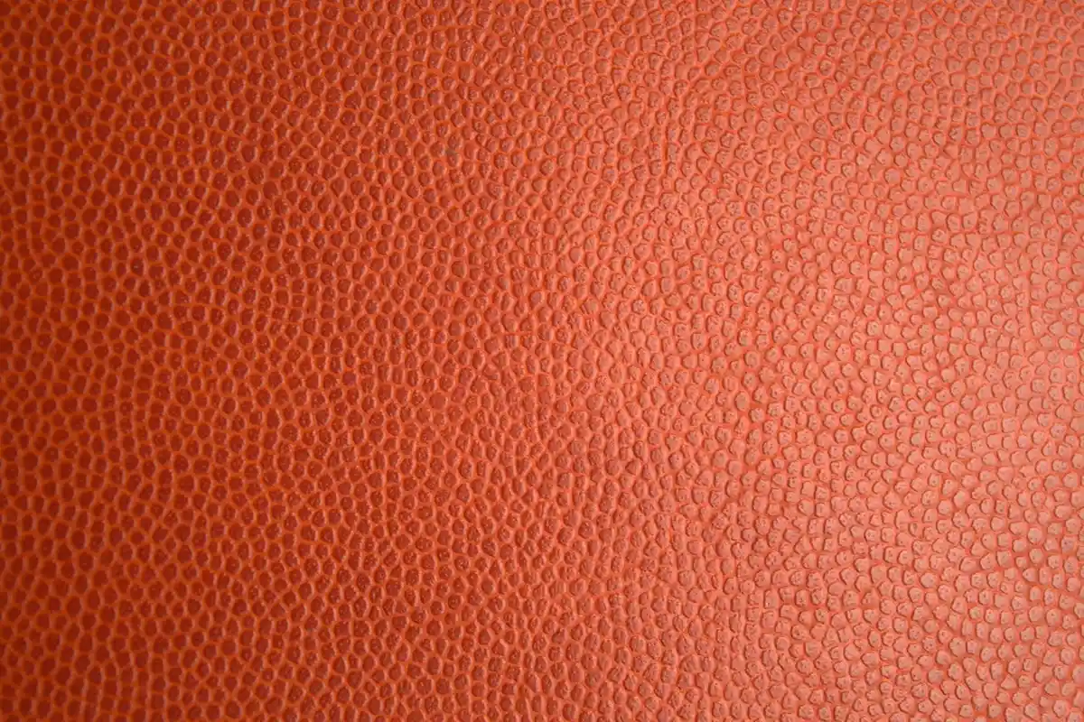 Close-up of orange pebbled leather texture with small rounded grains