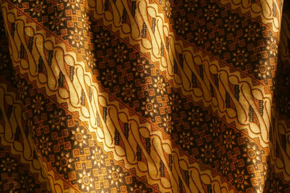 Close-up of a woven fabric with diagonal brown and gold patterns
