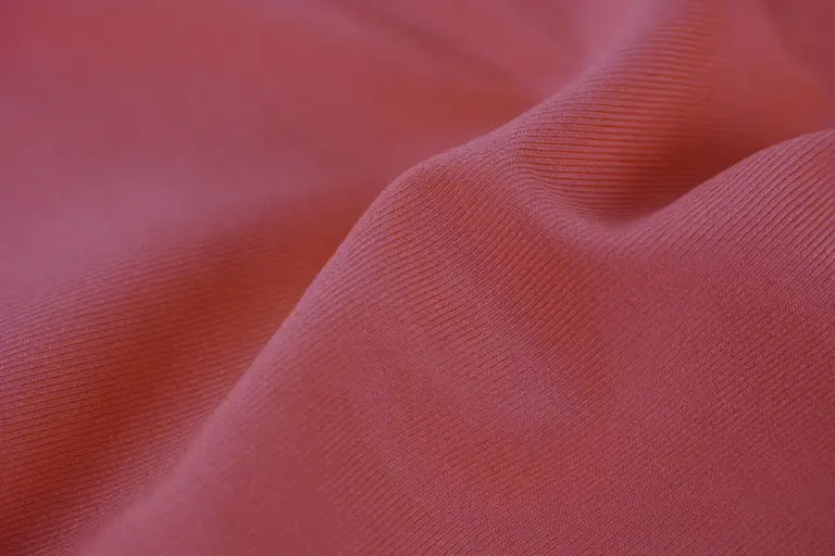 Close-up of pink fabric texture with gentle folds