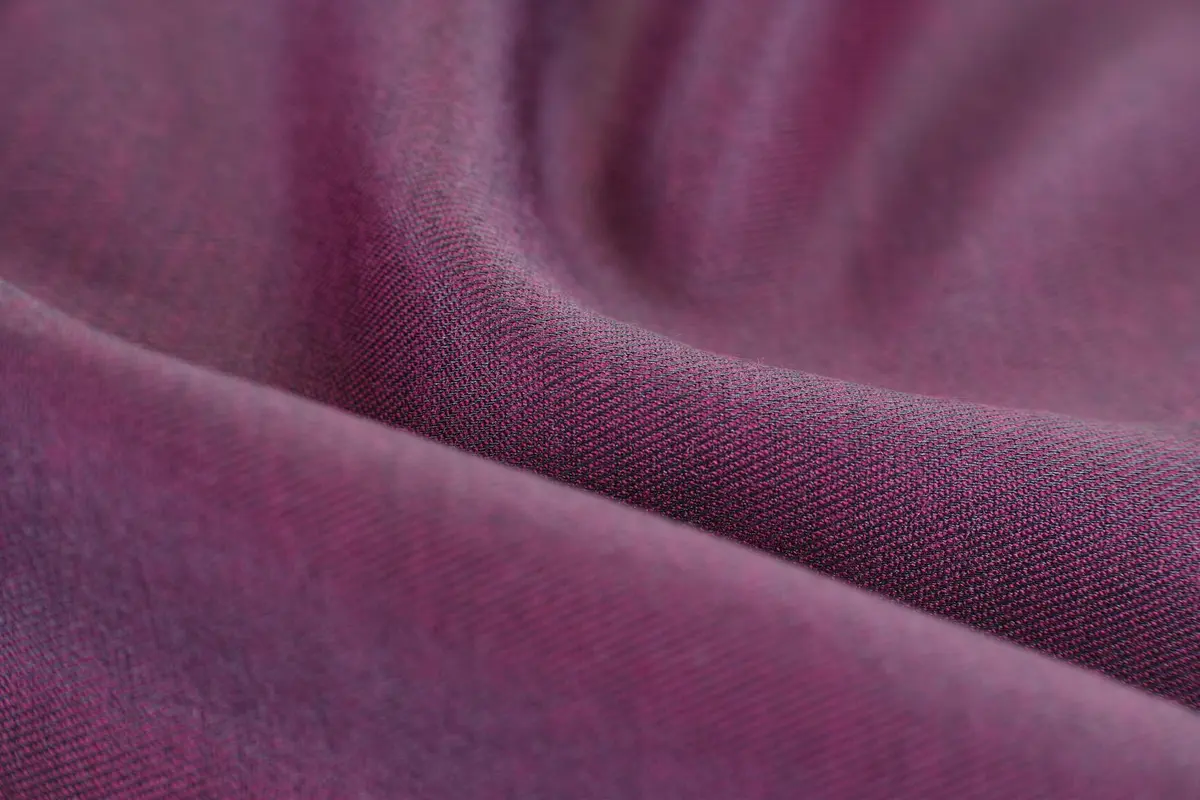 Close-up of soft, purple fabric with a smooth, drapey texture