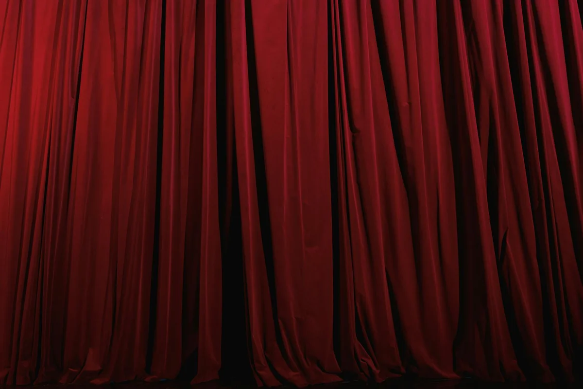 Close-up of deep red velvet curtain folds.