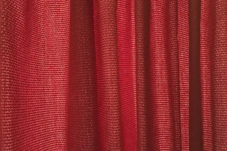 Close-up of red velvet fabric showing the nap and texture