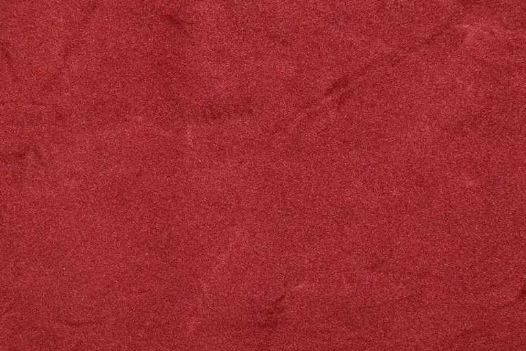 Close-up of red velvet fabric showing its nap and rich color