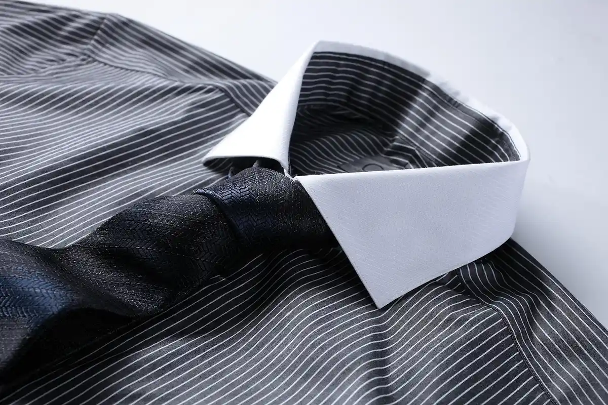 Close-up of a striped dress shirt collar and folds in the fabric
