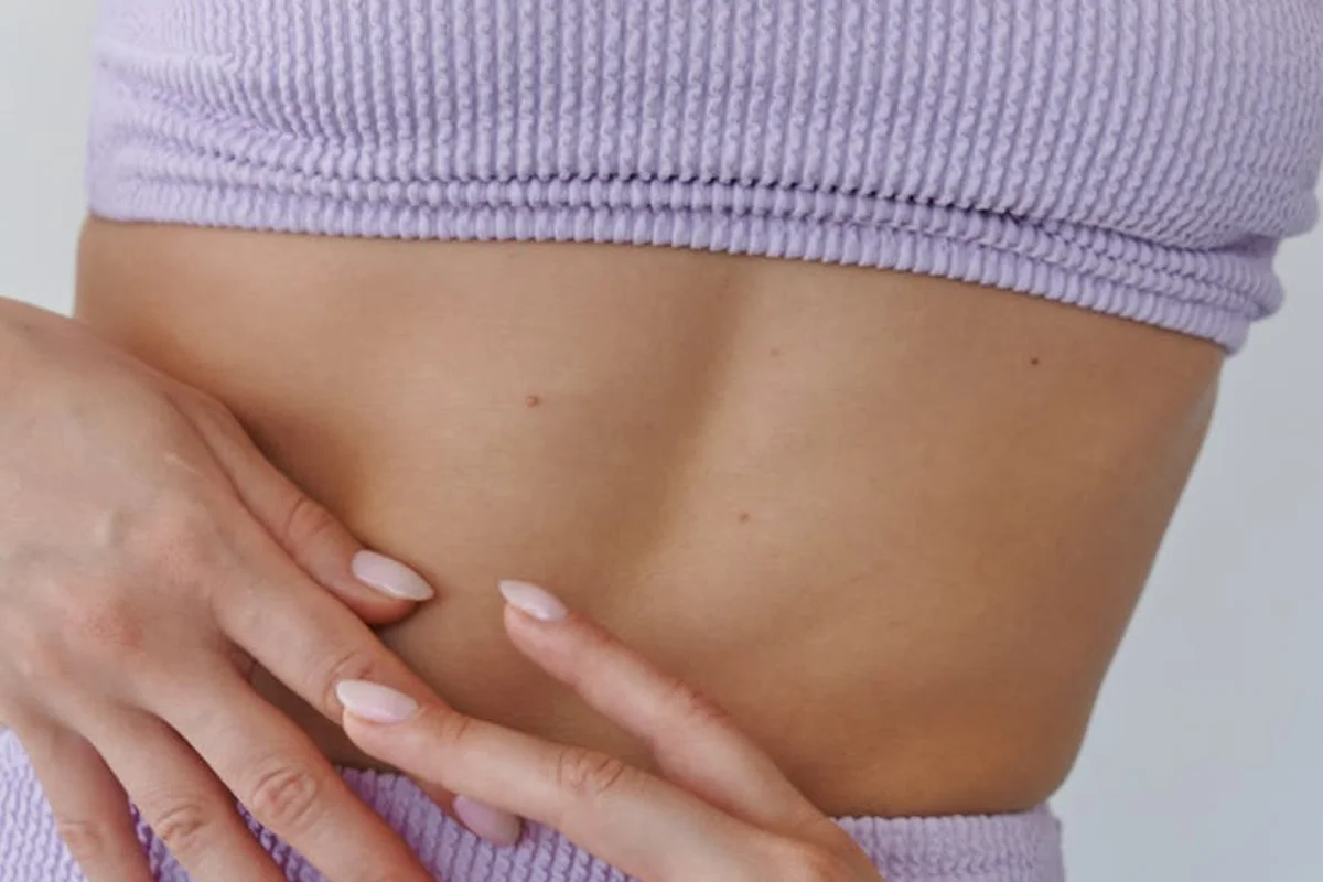 Close-up of a lavender ribbed fabric on a midriff, showcasing stretch material commonly used in spandex blends.