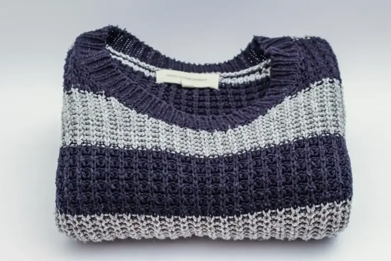 Folded navy and light-gray striped knit fabric sample.