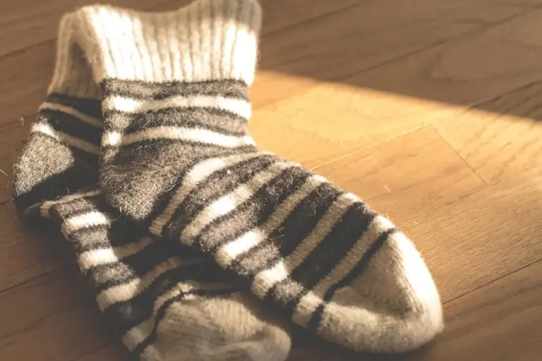 Close-up of striped wool socks on a wooden floor