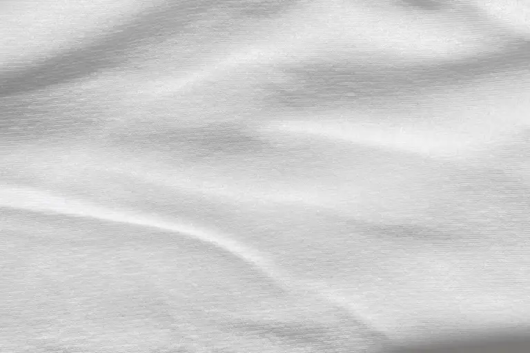 Light gray fabric texture with soft folds and wrinkles (viscose and rayon fabric) in grayscale