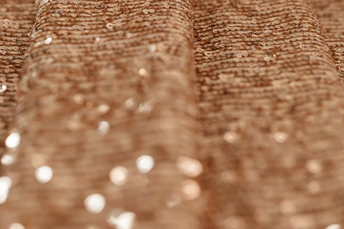 Close-up of brown viscose/rayon fabric with a textured weave and subtle sheen.