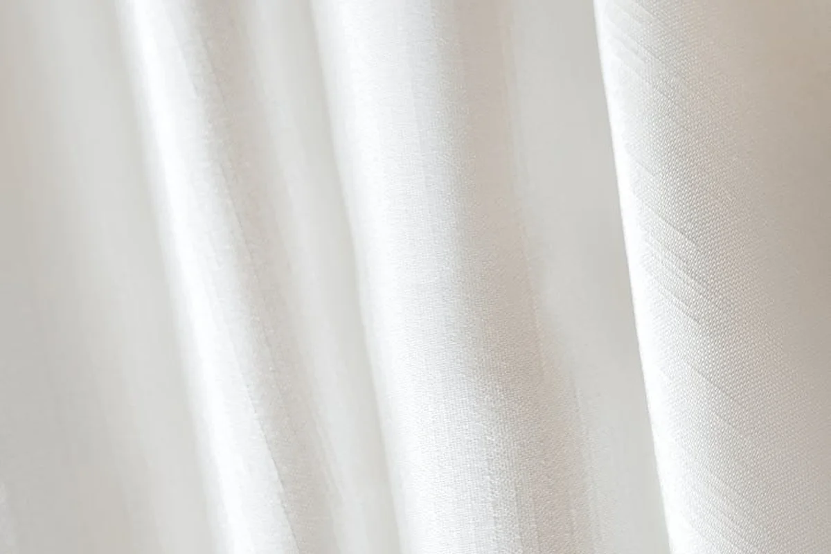 Close-up of white viscose fabric with soft folds and drape