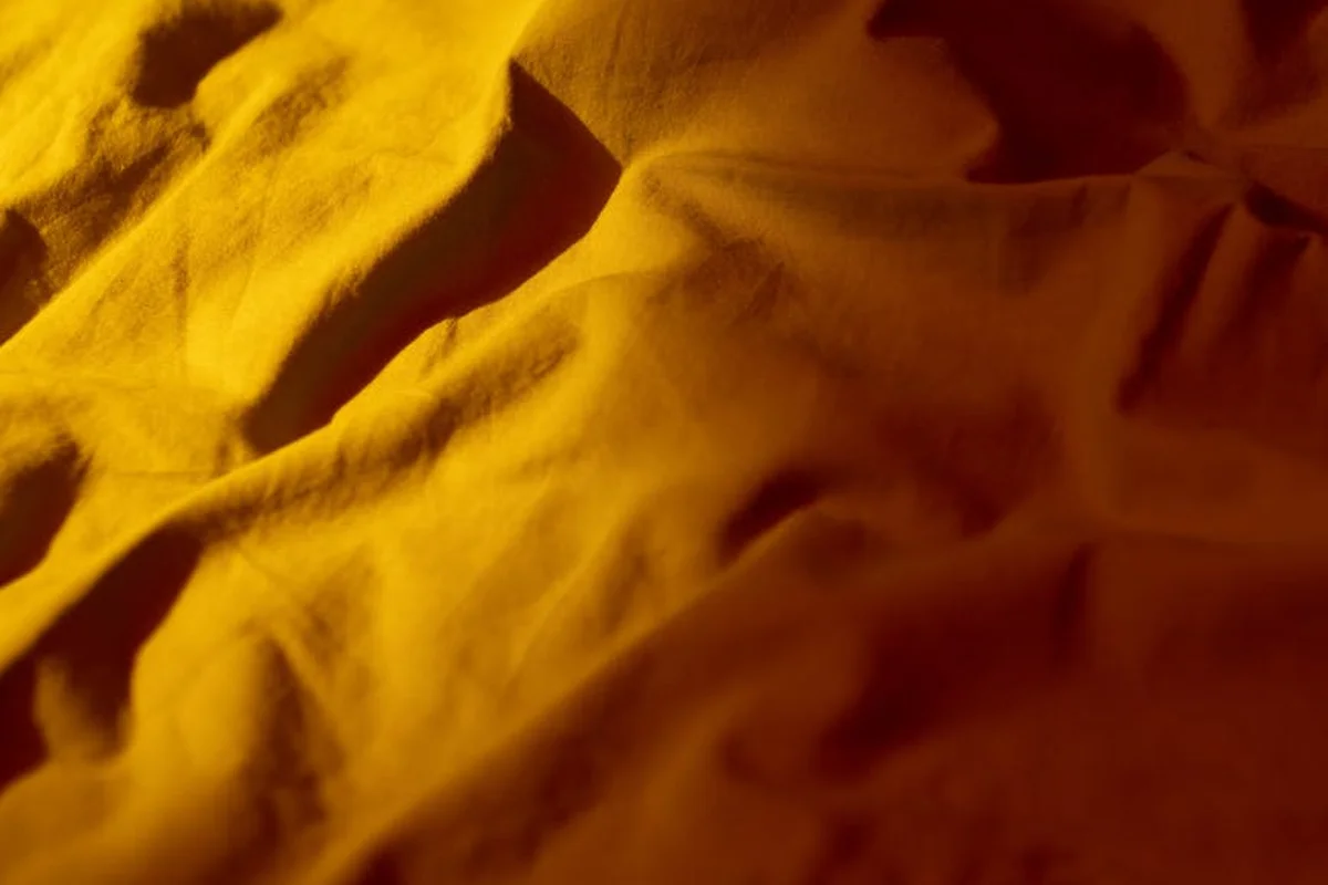 Close-up of wrinkled yellow-orange fabric